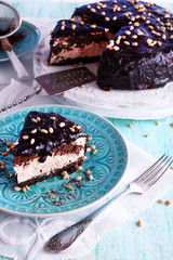 Delicious chocolate cake with icing in plate on table, closeup