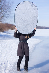 Photographer assistant holding reflector