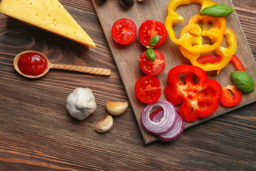Ingredients for cooking pizza on wooden table, top view