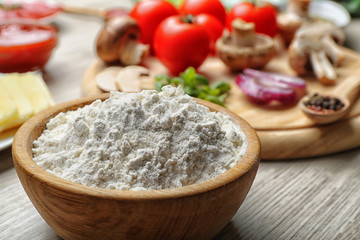 Ingredients for cooking pizza on wooden table, closeup