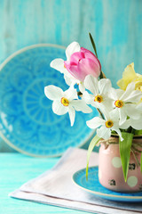 Spring bouquet in vase on color wooden background