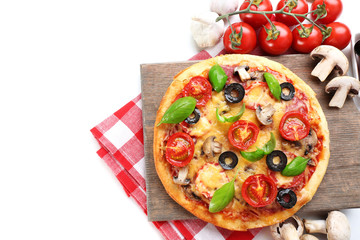 Tasty pizza with vegetables and basil on cutting board isolated on white