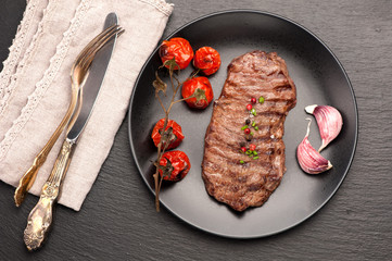Meat Ribeye steak entrecote with roasted tomatoes