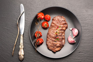 Meat Ribeye steak entrecote with roasted tomatoes and garlic