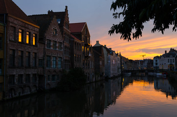 Naklejka premium Belgian town of Gent and its reflection in river Leie water