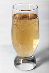 Glass of water with bubbles on table close up