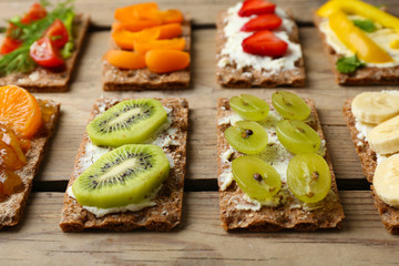Tasty vegetarian sandwiches on wooden table