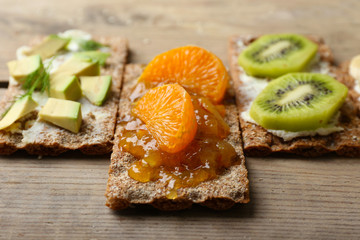 Tasty vegetarian sandwiches on wooden table
