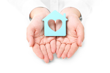 Obraz premium Female hands holding house, closeup