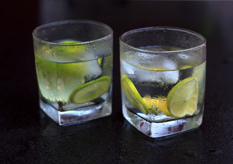 Lemonade served on a dark marble bar with a lime