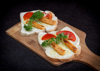 Sandwich with fried sausage, tomato, mayonnaise and parsley