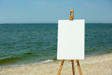 Easel with canvas on beach