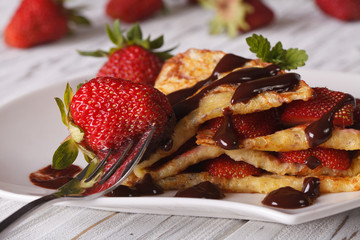Crepes with fresh strawberries and chocolate topping macro