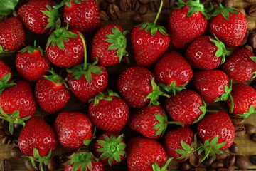 Fresh strawberry with coffee beans, closeup