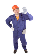 Working man smiling with hand raised.