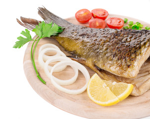 Fried carp tail with lemon and onion.