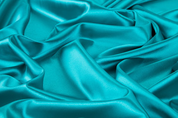 Obraz premium Soft folds of blue silk cloth texture.
