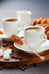 Fresh croissants  and cup of coffee on a table
