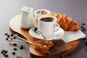 Fresh croissants  and cup of coffee on a table
