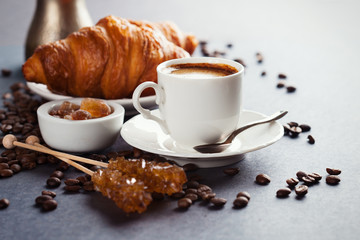 Fresh croissants  and cup of coffee on a table