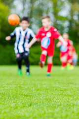 Obraz premium Blur of children playing soccer