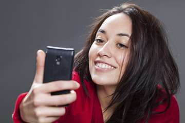 20s girl taking her selfie with seductive pose and smile