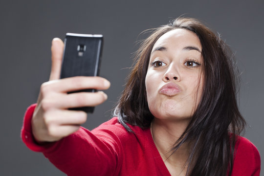 20s girl taking her selfie in sending kiss