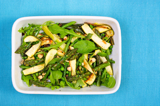 Asparagus, courgette and hazelnut salad in a rectangular dish fr