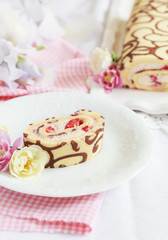 Homemade sponge roll with chocolate patterns, strawberries
