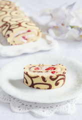 Homemade sponge roll with chocolate patterns, strawberries