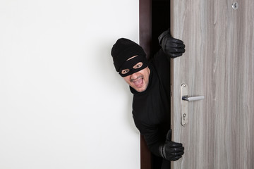 Burglar breaking in an apartment