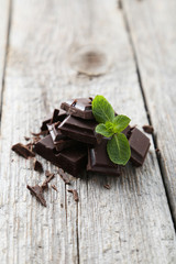 Fresh mint with chocolate on grey wooden background