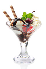 Vanilla ice cream in glass vase with chocolate topping and cherry