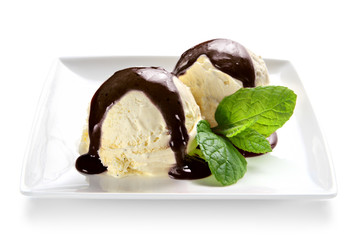 Ice cream scoops with chocolate sauce topping on a plate
