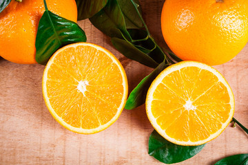 Oranges with shoots on a wooden table