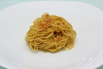 cooked egg noodles with fried galic on white plate