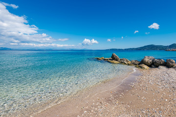 Fototapeta na wymiar Golden sandy beach and Mediterranean sea near Agios Ioannis Peristeron. Agios Ioannis Peristeron beach at Corfu island in Greece.