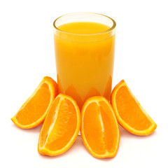 Orange juice in a glass and oranges