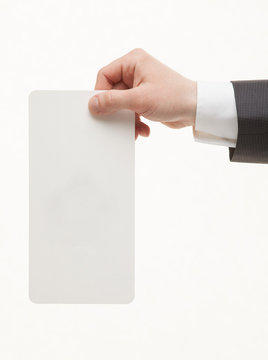 Unrecognizable businessman holding an empty paper card, closeup shot