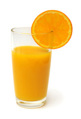 Orange juice in a glass and oranges