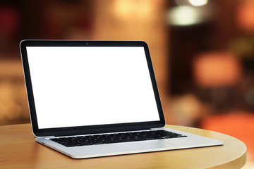 blank laptop in a cafe in the evening