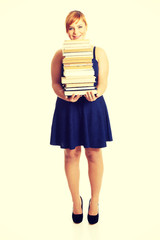 Overweight woman holding books