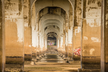 standing under old bridge over the river