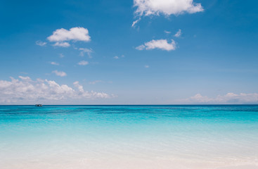 Fototapeta na wymiar blue sky with sea and beach - soft focus with film filter