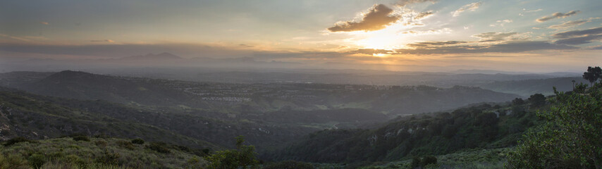 anoramic view of the sunrise from the top of the hiking trail at Alta Laguna Park, “Top of the World”, overlooking the saddleback mountains in Laguna Beach, Southern California © SailingAway