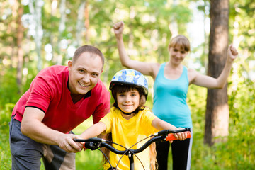 Family on cycle ride In forest