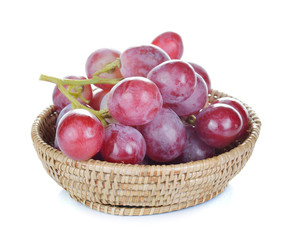 red grapes in basket on white background