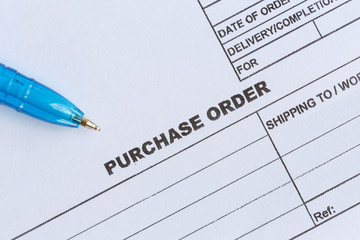 purchase order with blue pen in the office‏