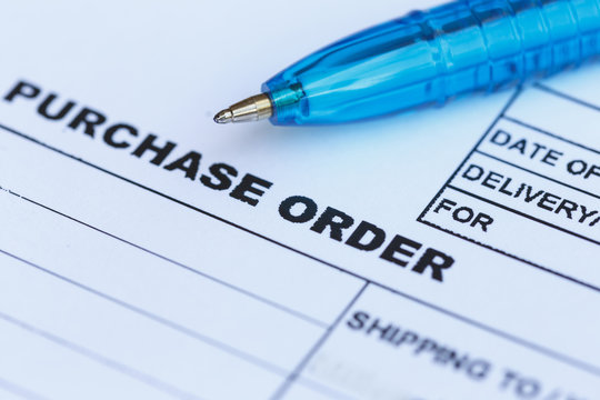 purchase order with blue pen in the office‏