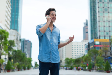 Handsome man cell phone call smile outdoor city street